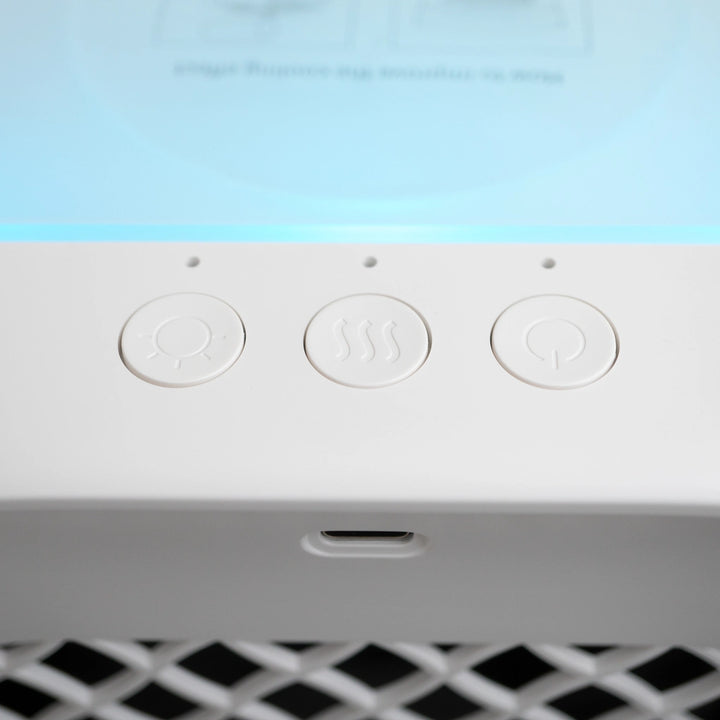 Close-up view of the control buttons on the white and grey air cooler