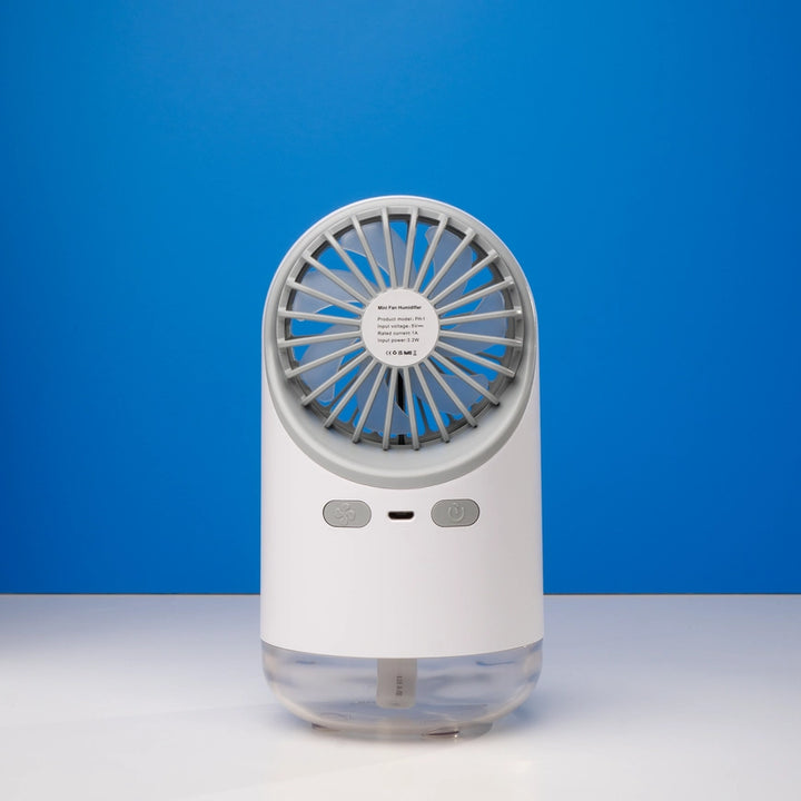White mini fan humidifier against a blue background