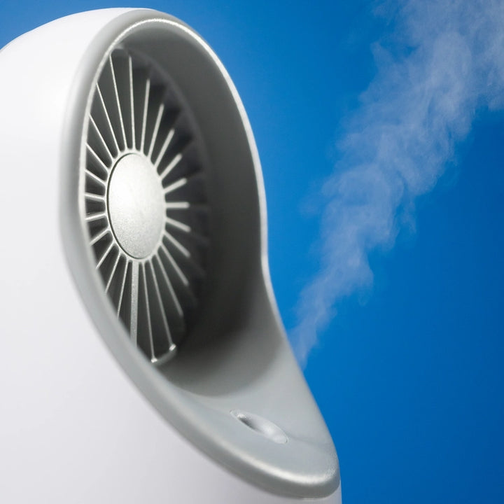 White mini fan humidifier showcased on a blue background