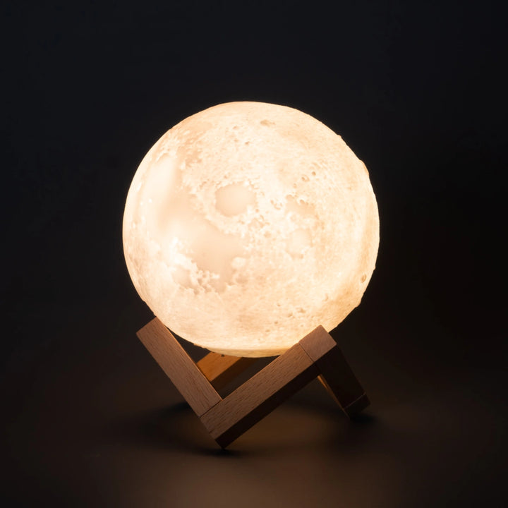 Moon-shaped humidifier lamp displayed on a wooden stand