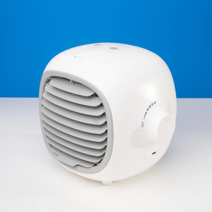 White portable air cooler positioned on a table