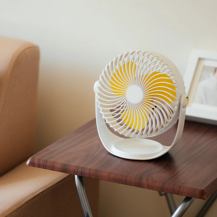 7 Inch Rechargeable Desk Fan in white positioned on a table next to a couch